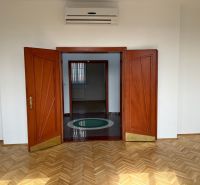 On Štefánikova Street, spacious offices with parquet floors and wooden doors.