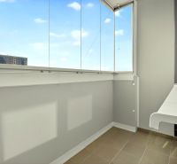 A closed balcony with a view of the city of Dubnica nad Váhom from Hurbanova Street.