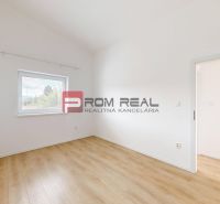A room with white walls and a wooden decor floor in a 3-room apartment.