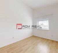 A bright room in a 3-room apartment with a wooden decor floor and a window.