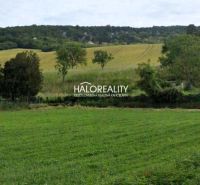 Fertile fields and hills near Hlohovec, surrounded by greenery in gardens and forests.