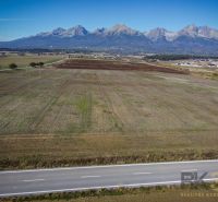 Plots - housing in Mlynica with a distant view of the mountains and an adjacent road.