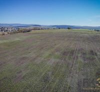 Extensive residential plots in Mlynica, visible vast nature and nearby dwellings.