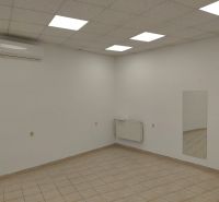 Commercial spaces with tiles, air conditioning, mirrors, and white walls.