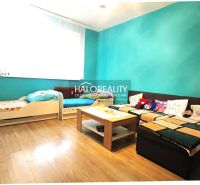 A children's room with colorful walls, a wooden decor floor, and comfortable furniture in a 3-room apartment.