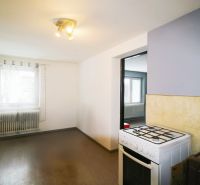 A kitchen in a family house with a gas stove and a floor with a wooden decor.