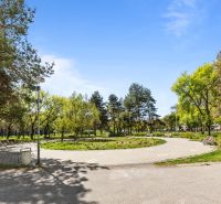 A park with benches and trees on Estónska Street in Bratislava - Podunajské Biskupice.