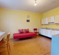 A room in a family house with a kitchen unit and a wooden decor floor.