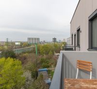A balcony with a view of greenery and the road on Hraničná Street in Bratislava - Ružinov.