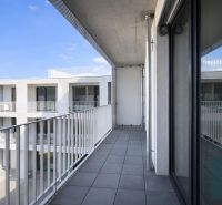 A balcony on Agátová Street in Bratislava - Dúbravka with a view of the white facade of a building.