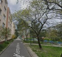 Kempelenova Street in Bratislava - Karlova Ves with a typical residential building and green trees.