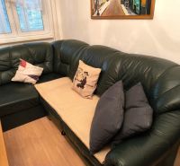 Leather sofa with cushions and wooden floor decor in a 3-room apartment.
