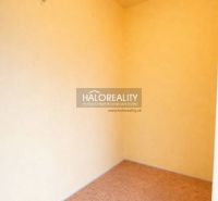 A small room with a wooden decor floor and light-colored walls.