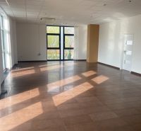 Spacious commercial premises with tiles and large windows, ideal for various purposes.