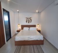 A room in a villa with a double bed and wall decoration.