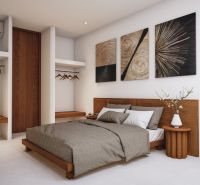 Design of a villa bedroom with art on the wall and a wooden decor floor.