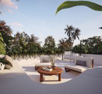 A villa in Bali with a spacious terrace, comfortable seating, and lush tropical greenery.