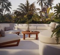Tropical terrace in a villa in Bali with comfortable seating and exotic vegetation.