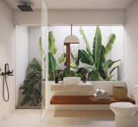 A bathroom in a villa with an open space, a modern shower, and large windows.