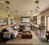 Living room with rustic furnishings, wood-patterned flooring, and a comfortable sofa.
