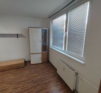 1-bedroom apartment with a wooden decor floor, furniture, and a large window with blinds.