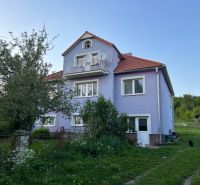A family house in Kosihovce with a purple facade and a garden.