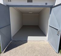 Open garages on Bezručova Street in Trenčín with white walls and a solid floor.