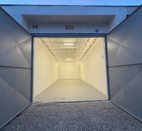Open garage on Bezručova Street in Trenčín with a white interior and gravel surface.