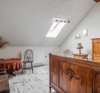 A room in a cottage with wooden furniture and a floor with a wooden decor.