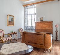A room in a cottage with wooden decor, classic furniture, and subtle accessories.