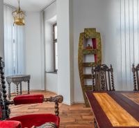 Interior of a cottage with historical furniture, wooden decor flooring, rich decorations.