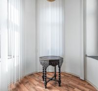 A small table with ornaments on the floor with a wooden decor in the cabin.