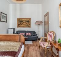 Bright room in a cottage with historical furniture and a wooden decor floor.