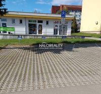 Commercial premises in Žiar nad Hronom with parking on paving, surroundings of buildings.
