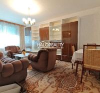 Living room with a comfortable sofa and a dining table in a 4-room apartment.