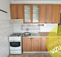 A kitchen in a 4-room apartment with wooden cabinets and a gas stove.