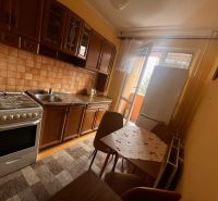 Kitchen in a 2-room apartment with a kitchen unit, stove, table, and chairs.