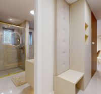 Interior of a 3-room apartment with a spacious bathroom and a shower with gold details.