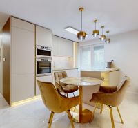 A kitchen in a 3-room apartment with a dining table and chairs, flooring with a wooden decor.
