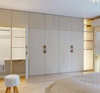 Bedroom in a 3-room apartment with wood-patterned flooring, built-in wardrobe, and mirror.