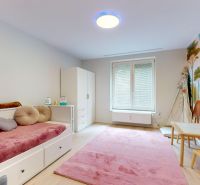Children's room in a 3-room apartment, includes a bed and toys, with dinosaur wallpaper.