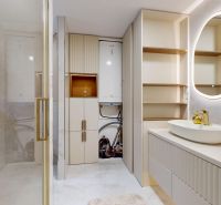 Luxury bathroom with a mirror, shower cabin, and modern storage space in a 3-room apartment.