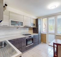 A kitchen in a 3-room apartment with a modern kitchen unit and a dining area.