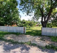 The plot surrounds a green area in Strážske, ideal for living with fruit trees.