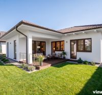 A family house in Drietoma with a terrace, a large grassy garden, and wooden decor.