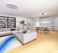 Living room in a family house with a spacious sofa, a bookshelf, and a floor with a wood decor.