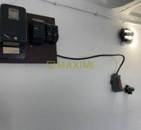 An electrical panel on the garage wall, a light on the wall.