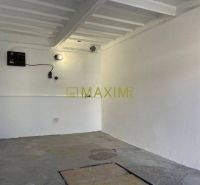 An empty interior with white walls and a concrete floor in a garage on Astronomická Street, Bratislava - Ružinov.