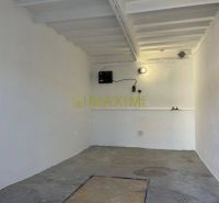 Garages on Astronomická Street in Bratislava - Ružinov with white walls and concrete floor.