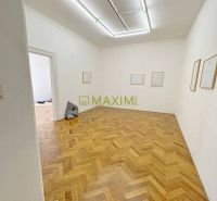 A room in a 3-room apartment with a wood-patterned floor and white walls.